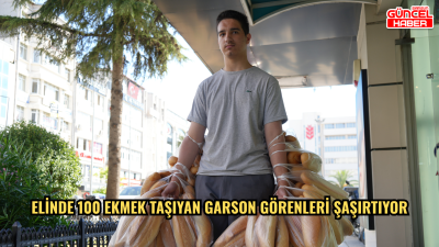 Elinde 100 ekmek taşıyan garson görenleri şaşırtıyor